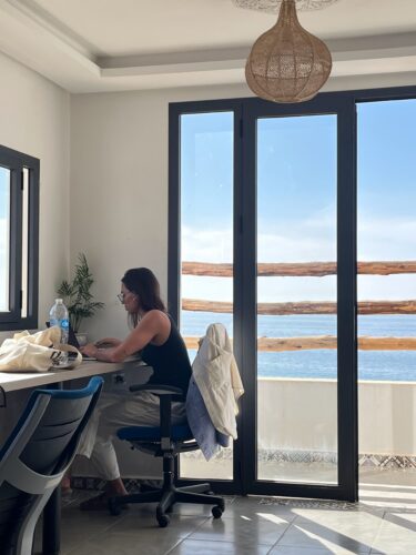 Woman working coworking space Taghazout Morocco ocean view BB Hostel Surf Camp Taghazout